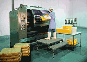 Derek Giels operates a piece of heavy machinery at the Softee Loaf factory in Garland, TX.